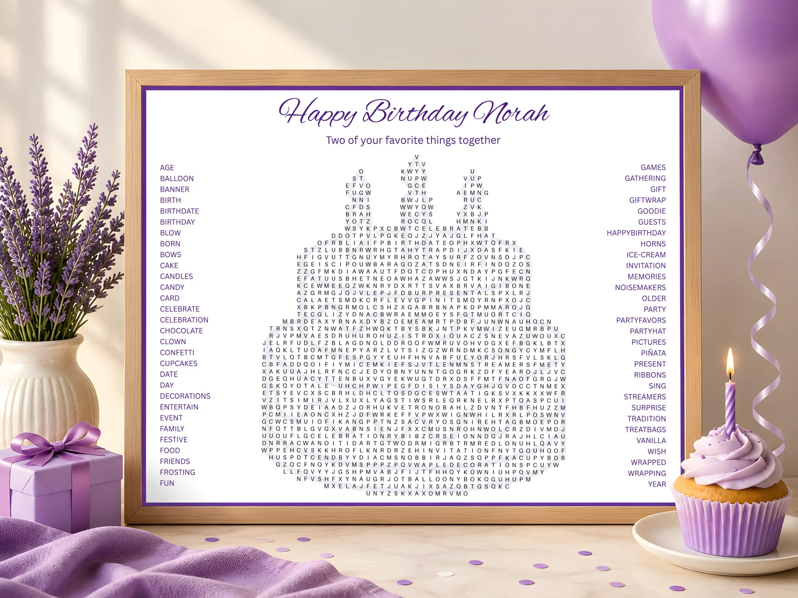 A personalized cake-shaped word search poster reading 'Happy Birthday Norah', framed beside lavender, a gift, and a cupcake